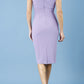 model is wearing diva catwalk polly cap sleeve pencil dress with rounded neckline at the front and deep lowered rounded cutout at the back in chalk purple back
