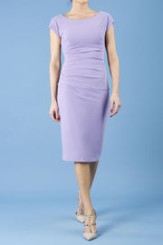 model is wearing diva catwalk polly cap sleeve pencil dress with rounded neckline at the front and deep lowered rounded cutout at the back in chalk purple front
