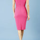 model is wearing diva catwalk polly cap sleeve pencil dress with rounded neckline at the front and deep lowered rounded cutout at the back in fuchsia pink back