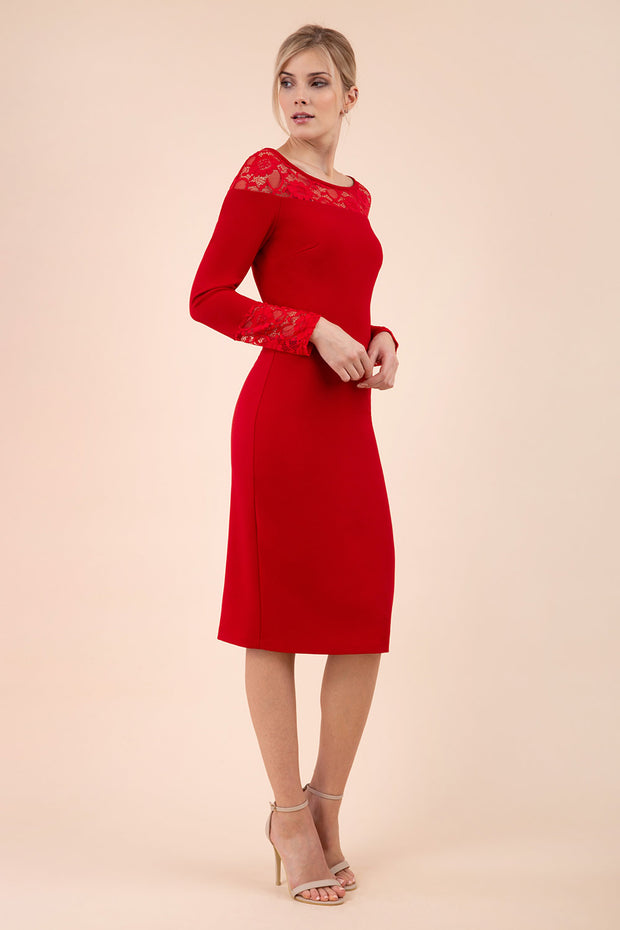brunette model wearing diva catwalk red lace pencil dress with long sleeves and rounded lace neckline with the lace covering shoulders front