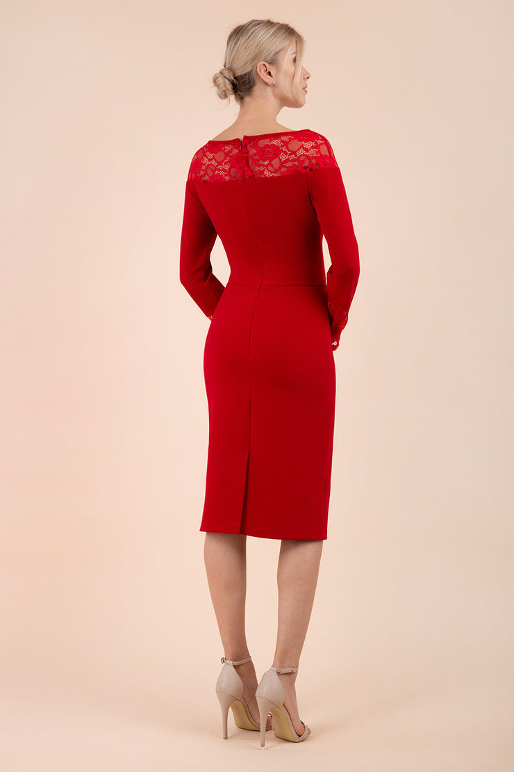 brunette model wearing diva catwalk red lace pencil dress with long sleeves and rounded lace neckline with the lace covering shoulders back