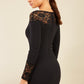 brunette model wearing diva catwalk black lace pencil dress with long sleeves and rounded lace neckline with the lace covering shoulders back
