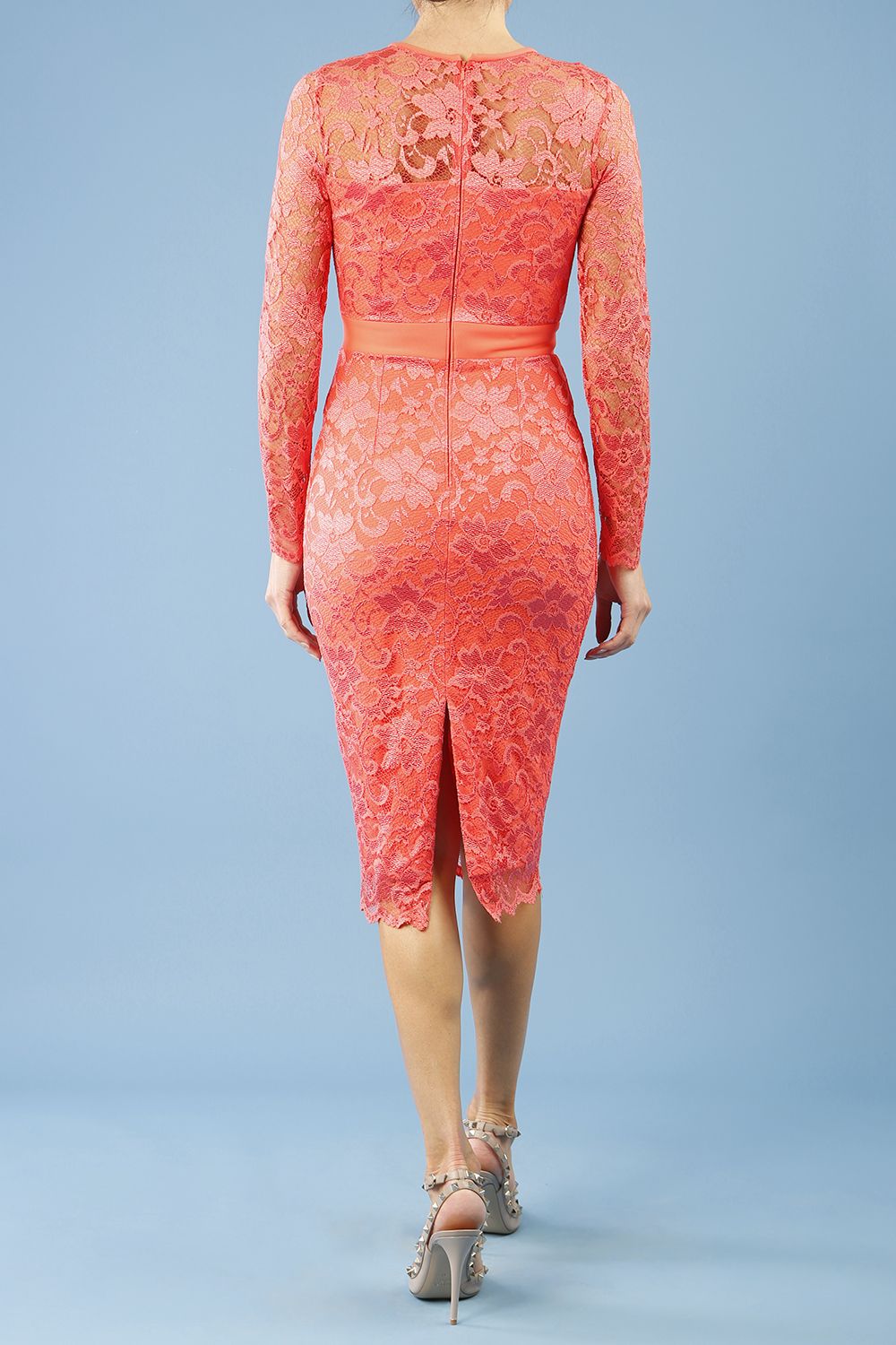 Model wearing the Diva Cherrie Lace Pencil dress with long sleeves and round neck in hot coral back