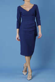model is wearing diva catwalk regatta low v-neck sleeved pencil dress in navy blue front