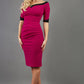 blonde model is wearing diva catwalk fellini sweetheart neckline fitted pencil dress with sleeves with cuff in colour pink with black contrasting detail front