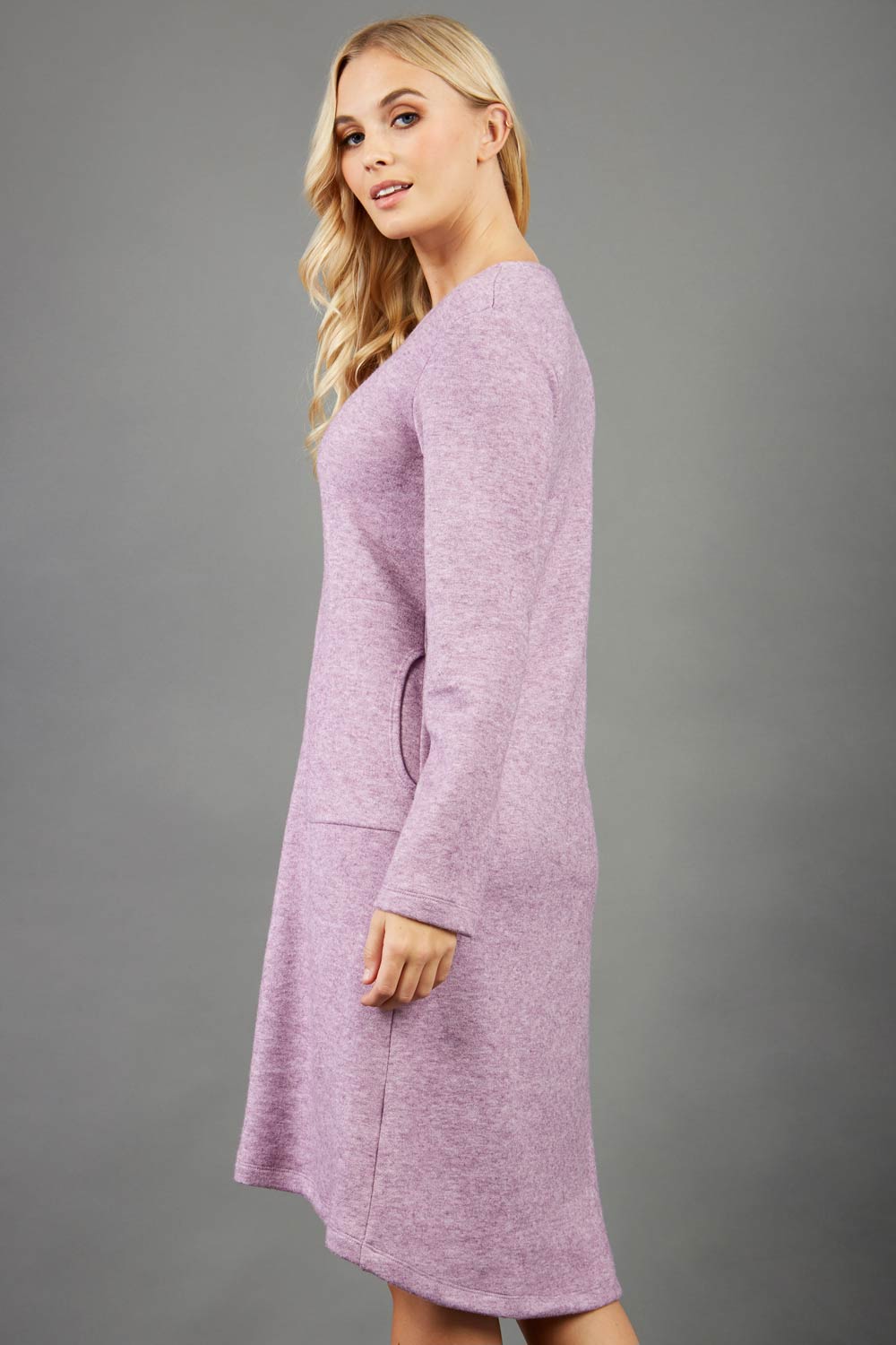 blonde model wearing diva catwalk irena cosy sleeved knee length dress with pockets and v-neckline in soft fabric pink front