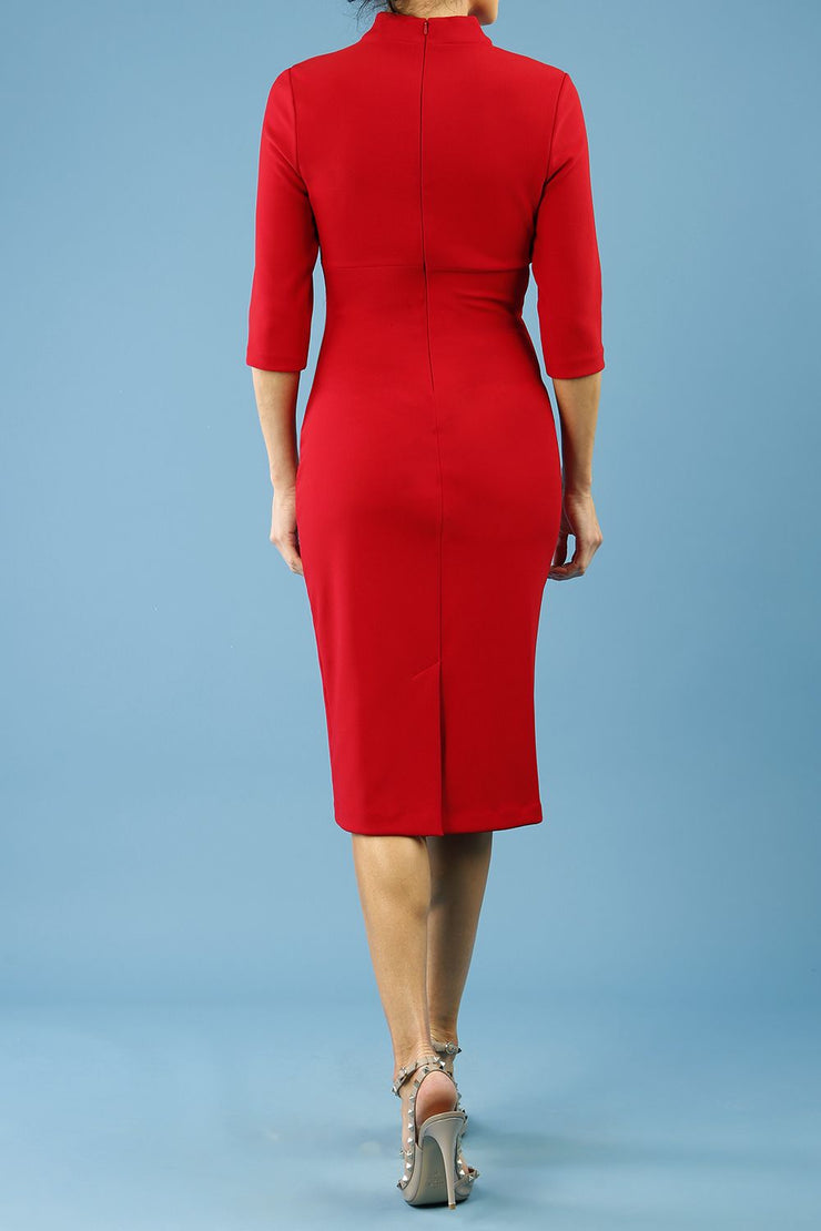 model is wearing diva catwalk pinhoe pencil dress with sleeved and high neckline with a keyhole detail in the middle and pleating across the tummy area in true red back