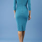 model is wearing diva catwalk polly sleeved pencil dress with low rounded neckline at the back in mosaic blue back