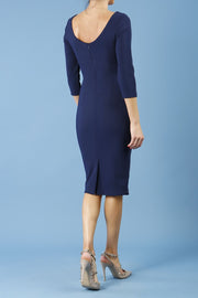 model is wearing diva catwalk polly sleeved pencil dress with low rounded neckline at the back in navy blue back
