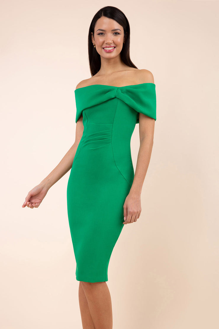 blonde model is wearing diva catwalk mariposa pencil dress with Detailed Bardot neckline with fold-over detail and pleated at waist area in emerald green front