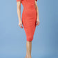 blonde model is wearing diva catwalk mariposa pencil dress with Detailed Bardot neckline with fold-over detail and pleated at waist area in grenadine orange front