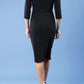 model is wearing diva catwalk quatro sleeved pencil dress with asymmetric wide cut our neckline in black back