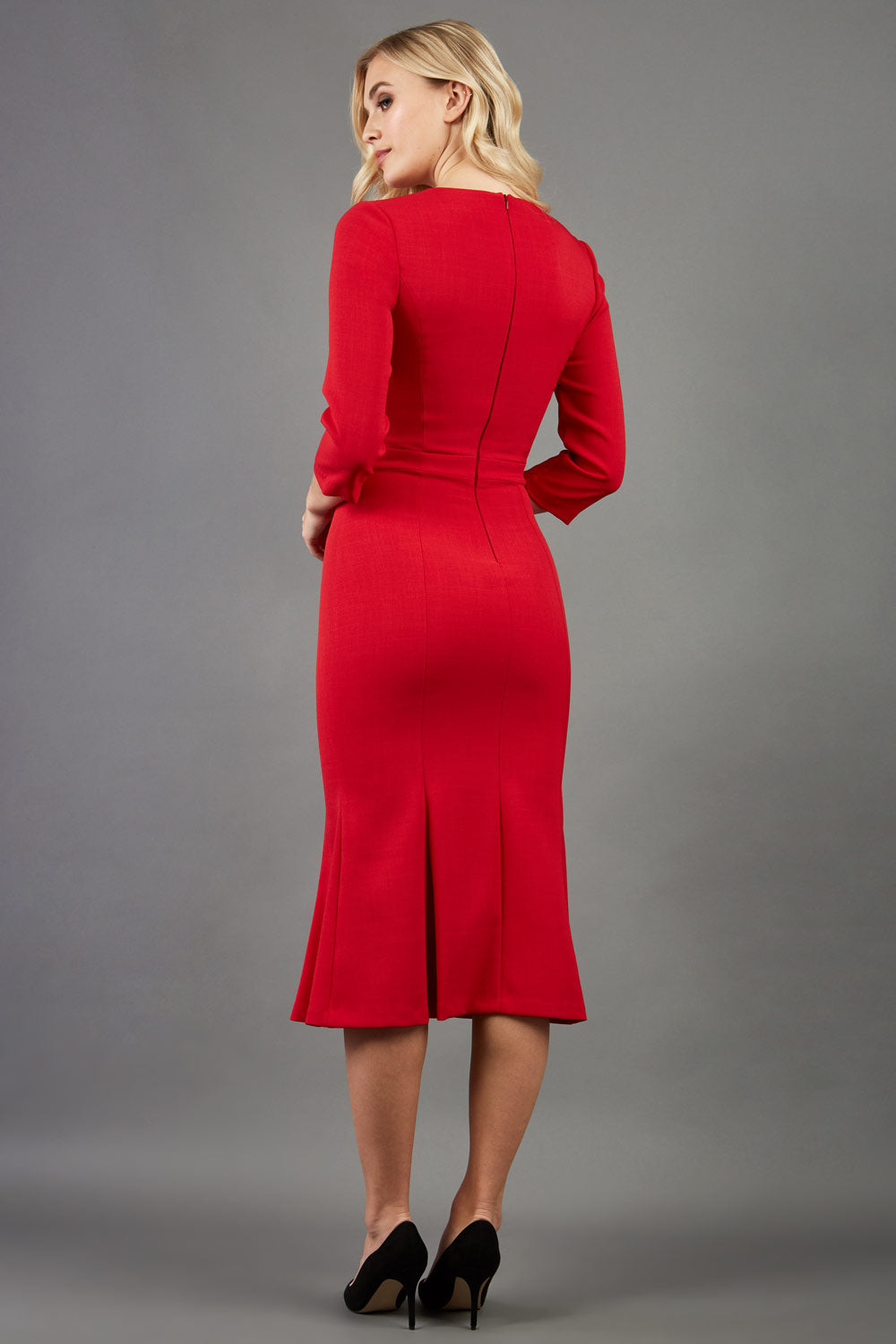 blonde model is wearing diva catwalk senne midaxi sleeved dress with fishtail and rounded neckline with a slit in the middle in red back