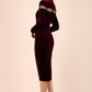 blonde model wearing diva catwalk burgundy pencil dress called trocadero pencil midaxi style with funnel neckline and lace detail and long sleeves back