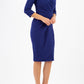 model wearing diva pencil dress tulip design with overlapping pencil skirt with 3 4 sleeves in colour oxford blue front 