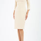 blond model wearing diva catwalk nashville plain pencil skirt dress with sleeves and square neckline and Empire waistline in beige cream colour front