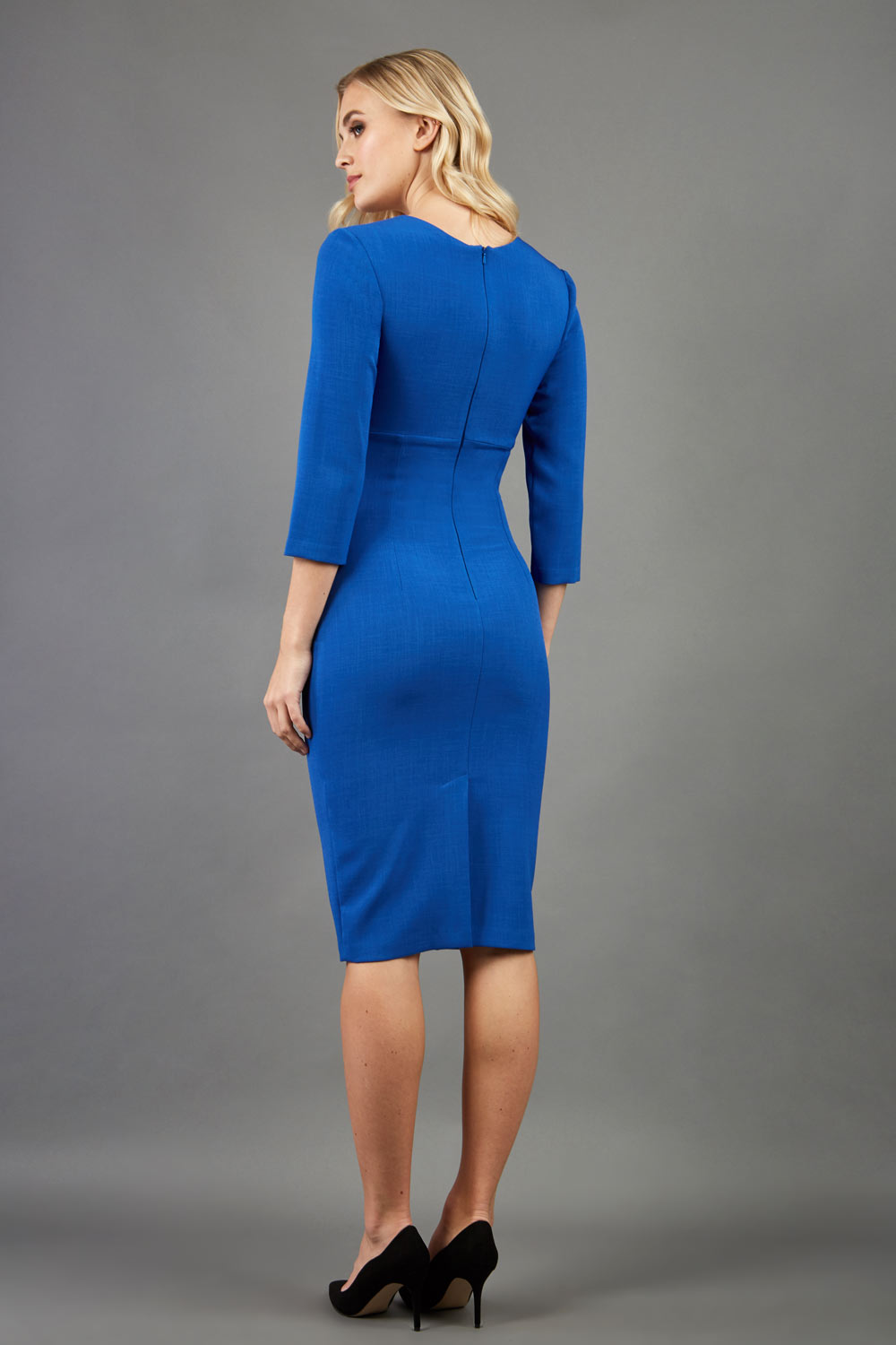 blond model wearing diva catwalk nashville plain pencil skirt dress with sleeves and square neckline and Empire waistline in royal blue colour back