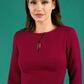 brunette model wearing diva catwalk ubrique pencil dress with a keyhole detail and sleeves in wine colour front