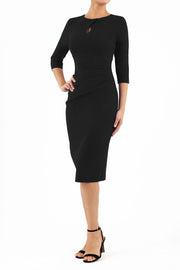 brunette model wearing diva catwalk ubrique pencil dress with a keyhole detail and sleeves in black front