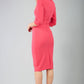 brunette model wearing diva catwalk ubrique pencil dress with a keyhole detail and sleeves in fuchsia pink back