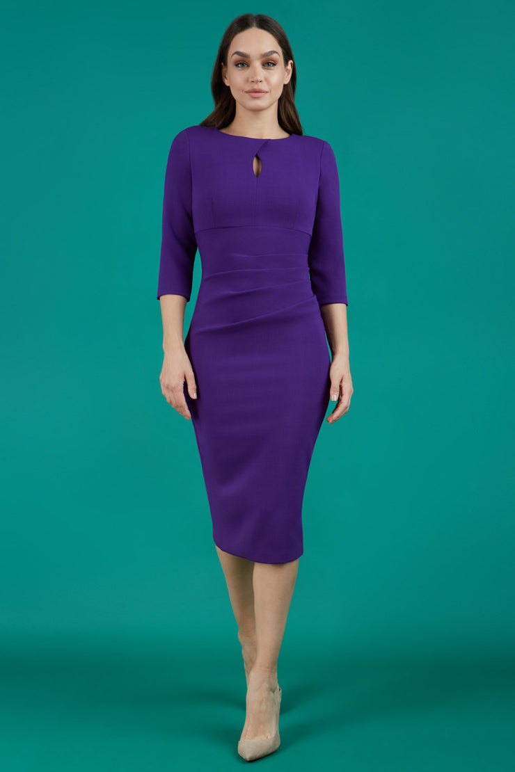 brunette  model wearing diva catwalk ubrique pencil dress with a keyhole detail and sleeves in purple colour front
