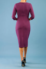 model is wearing diva catwalk ubrique pencil dress with sleeve and keyhole detail on a front panel in imperial purple back