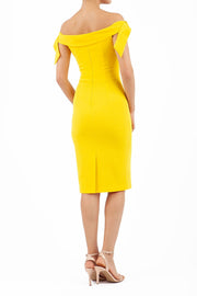 Model wearing the Diva Calista dress, off shoulder design, sleeveless pencil in freesia yellow back image