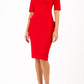 Model wearing Diva catwalk Derwent Pencil skirt dress with shoulder pads and short sleeves and pockets on both sides and empire waistline in true red front