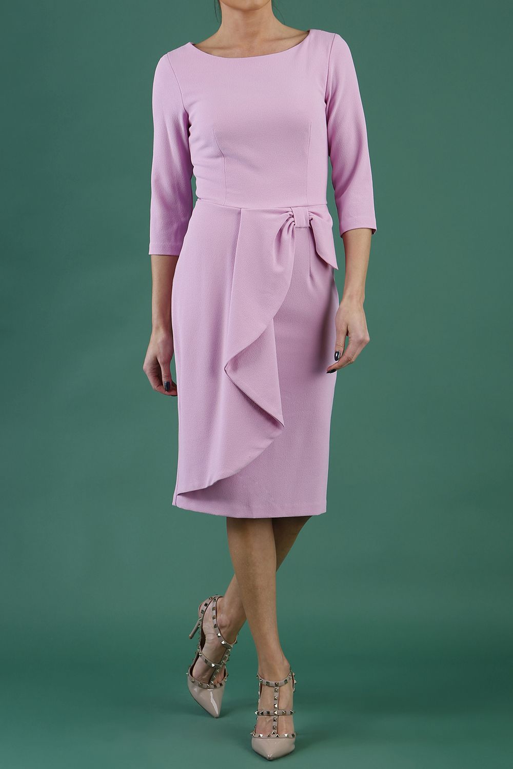 model is wearing diva catwalk jacky dress with rounded neckline 3/4 sleeve and bow detail on the waist in dawn pink front