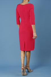 model is wearing diva catwalk jacky dress with rounded neckline 3/4 sleeve and bow detail on the waist in honeysuckle pink back 