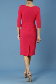 model is wearing diva catwalk jacky dress with rounded neckline 3/4 sleeve and bow detail on the waist in honeysuckle pink back