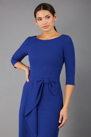 model is wearing diva catwalk jacky dress with rounded neckline 3/4 sleeve and bow detail on the waist in oxford blue front 