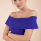 blonde model wearing diva catwalk peplum pencil skirt dress in indigo blue colour off shoulder bardot neckline front