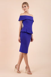 blonde model wearing diva catwalk peplum summer pencil dress in indigo blue colour off shoulder bardot neckline front