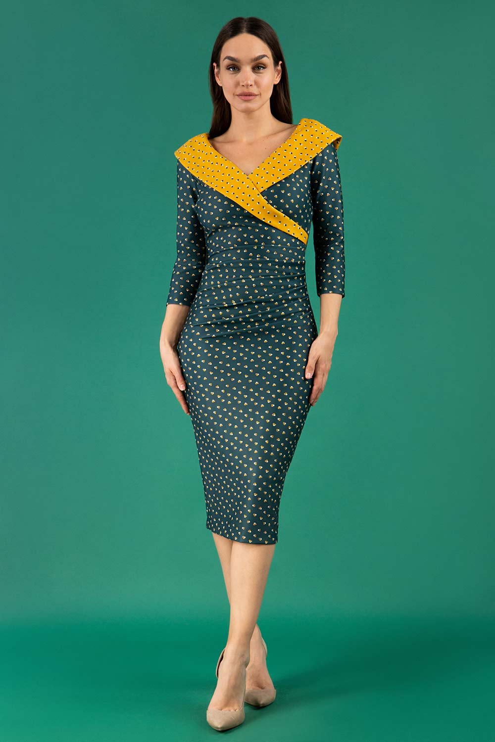 A brunette model is wearing a bi stretch pencil print mustard green dress by diva catwalk
