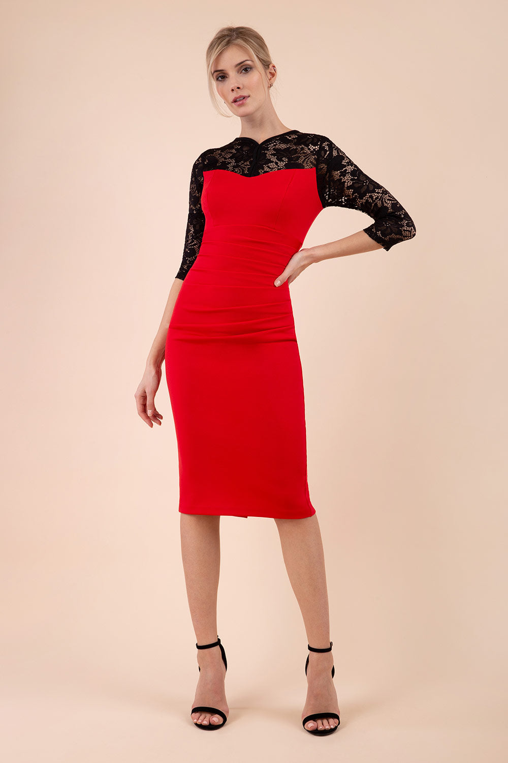 blonde model wearing diva catwalk haversham three quarter contrast pencil dress with lace detail across arms and neckline with pleating cross body in red and black front