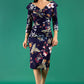 A brunette model is wearing a bi stretch pencil print wildflower dress by diva catwalk