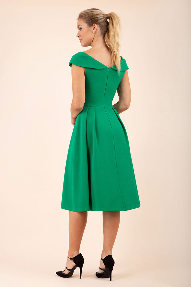 blonde model wearing diva catwalk Chesterton Swing Sleeveless dress in emerald green back