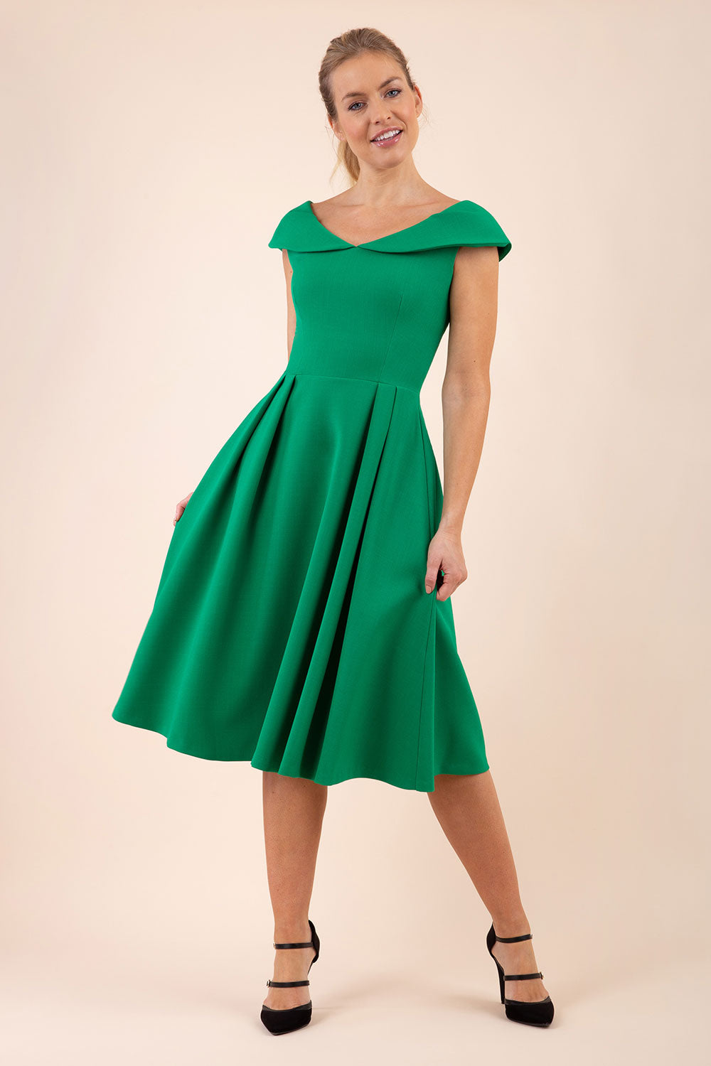 blonde model wearing diva catwalk Chesterton a-line skirt Swing Sleeveless dress in emerald green front