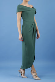 brunette model is wearing the diva catwalk vegas midaxi calf length dress off shoulder in hunter green side