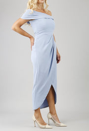 model wearing diva catwalk vegas calf length powder blue midaxi dress with wide bardot neckline and open shoulders with a large opening at the front of the skirt with pleating coming down long skirt front