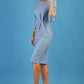blonde model is wearing diva catwalk logan round neck sleeved pencil dress with side arrow pleating detail in steel blue front