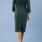 model is wearing diva catwalk miracle pencil dress with keyhole detail on a side of the front panel and gathering detail on a side or bodice panel with sleeves in forest green colour back