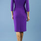 brunette model is wearing diva catwalk pencil dress with collar and a button detail on a side with 3/4 sleeve in passion purple back