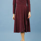 model is wearing diva catwalk westgate low v-neck wrapped swing skirt dress with long sleeves in burgundy sparkle colour front