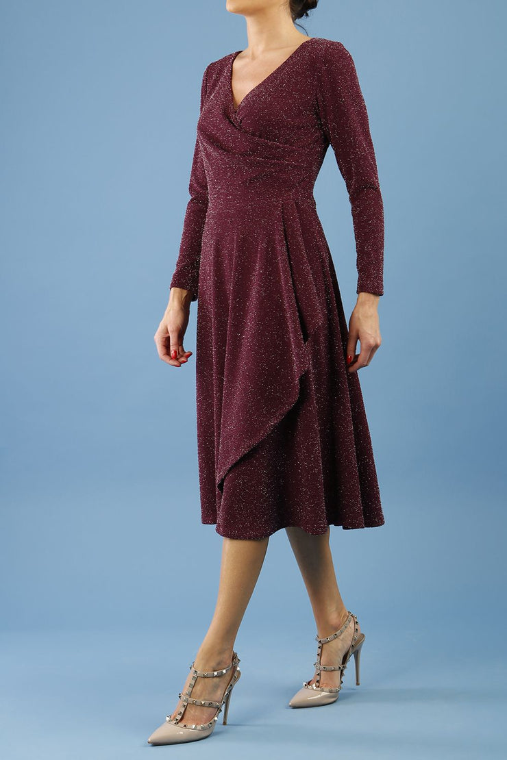 model is wearing diva catwalk westgate low v-neck wrapped swing skirt dress with long sleeves in burgundy sparkle colour front