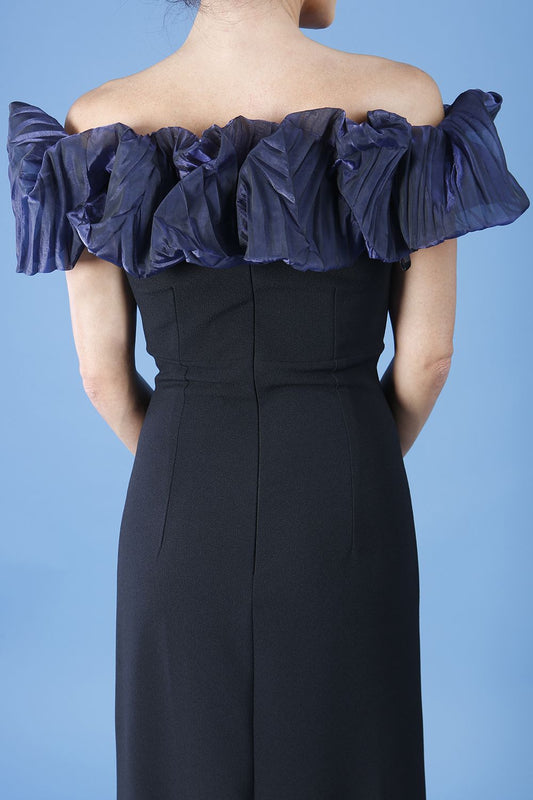 brunette model is wearing diva catwalk classique maxi black dress with off shoulder organza detail without sleeves in black and navy back