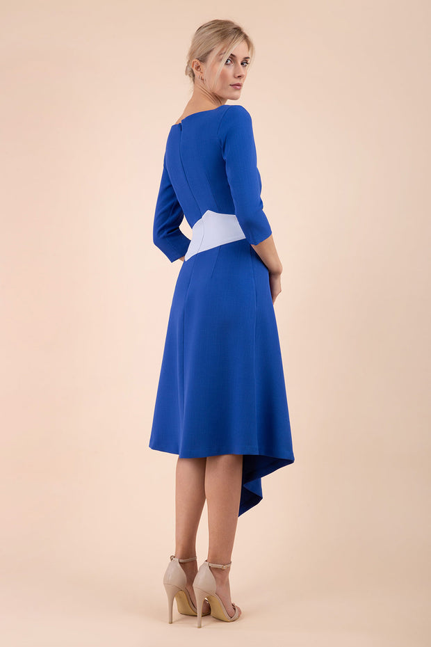 Blonde Model wearing Diva Catwalk Pinto Contrast Swing Dress with asymmetric skirt and asymmetric neckline with three quarter sleeve in Cobalt Blue back