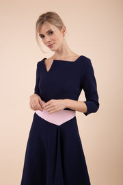 Blonde Model wearing Diva Catwalk Pinto Contrast Swing Dress with asymmetric skirt and asymmetric neckline with three quarter sleeve in Navy Blue front
