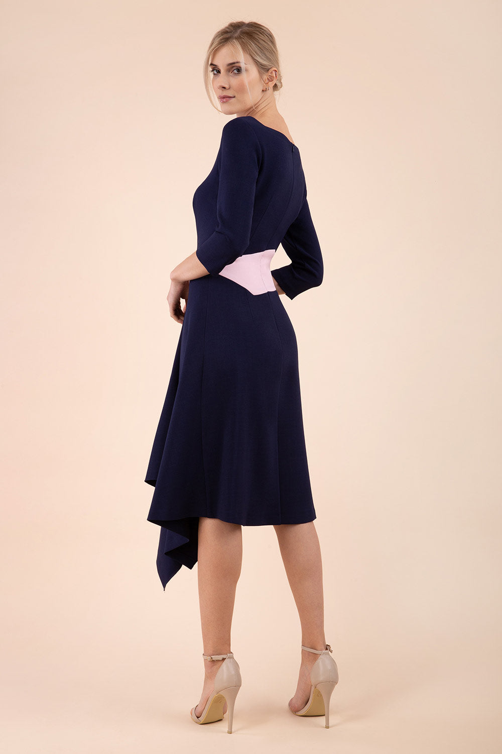 Blonde Model wearing Diva Catwalk Pinto Contrast Swing Dress with asymmetric skirt and asymmetric neckline with three quarter sleeve in Navy Blue back